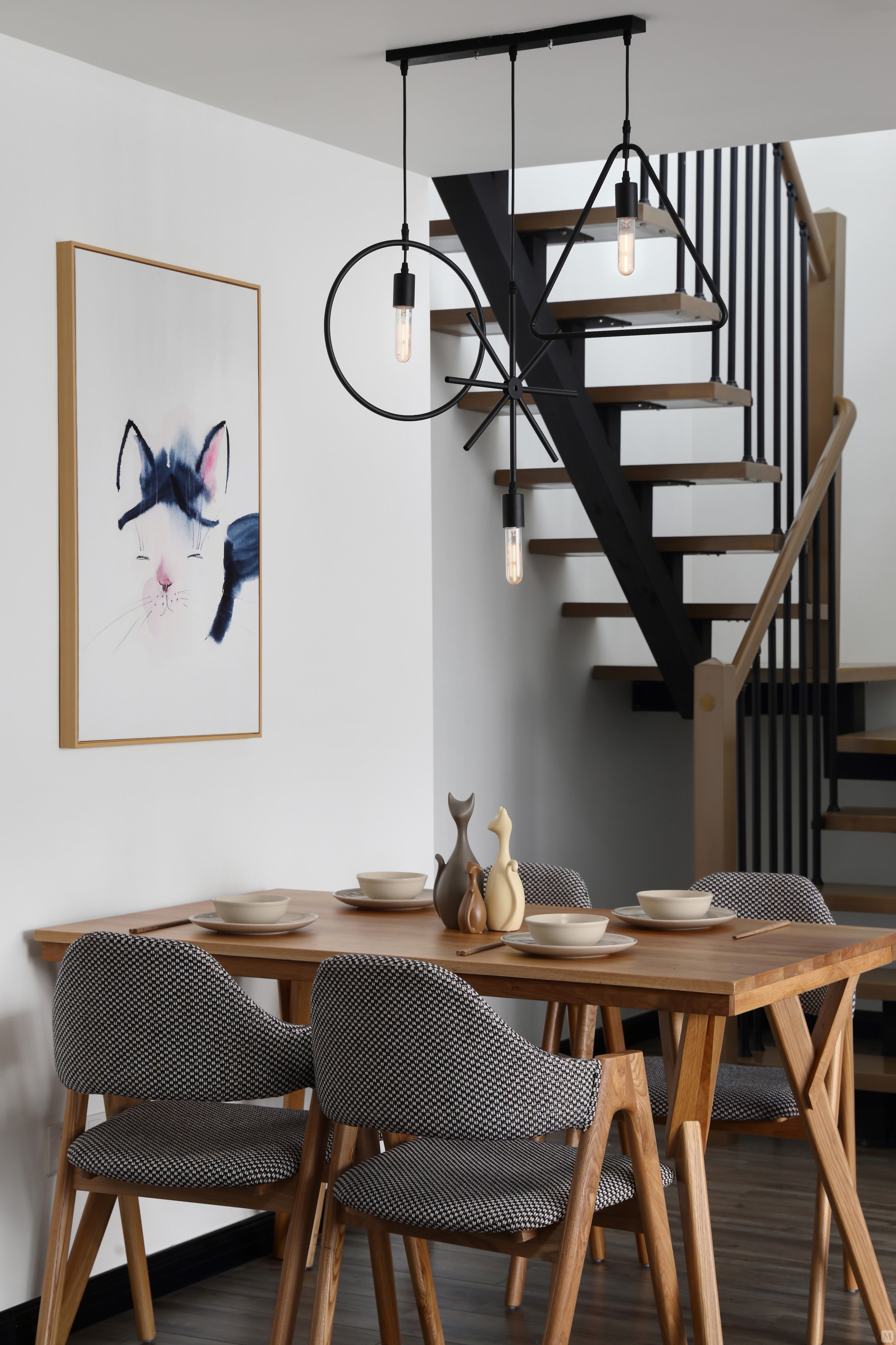 餐厅的铁艺吊灯很有特色,搭配原木餐桌椅十分和谐,加上装饰挂画的点缀